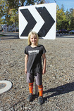 student in front of road sign