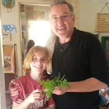 man with child holding plant