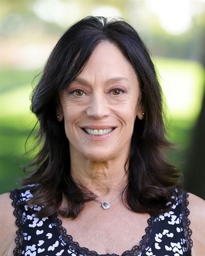 smiling white woman with brown hair and brown eyes